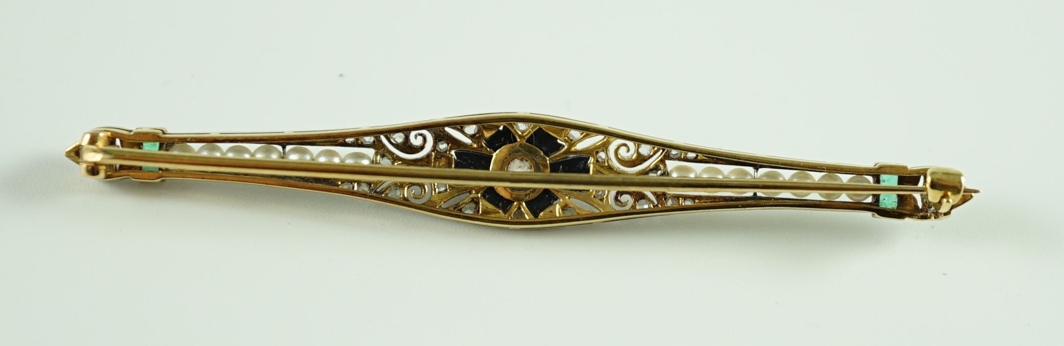 A 1920's gold and platinum, emerald, seed pearl, diamond and black onyx set bar brooch